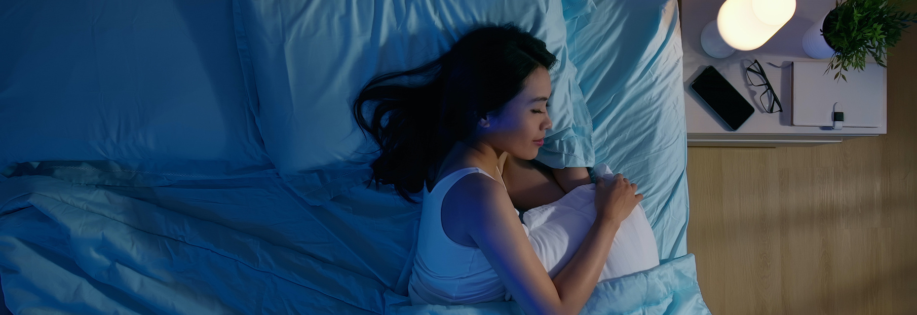 Woman sleeping in her bed